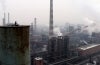 Factory scene with many smokestacks.