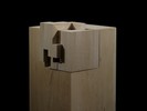 Photograph of bass wood cube model on basewith shifted portions of the cube.