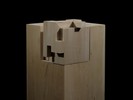 Photograph of bass wood cube model on basewith shifted portions of the cube.