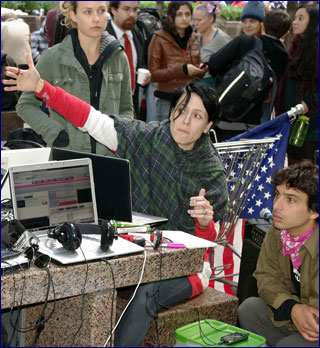 Scene from the Occupy Wall Street protests of people around a table covered with laptops and cell phones.