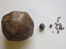 Large garnet trapezohedron and smaller garnet crystals.