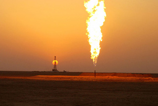 Oil rig and flare at sunset.