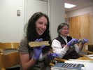 Photo of students holding up and playing with various slide rules.