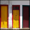 Photograph of three doors in a row.