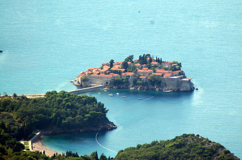 a cluster of old houses on a rocky tombolo