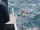 Two orange floats on the ocean's surface.