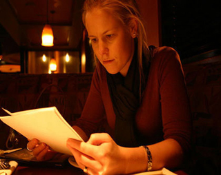 Photograph of a woman reading a script.