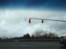 Traffic lights on a dark, cloudy, day in the winter.