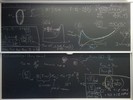 Ion-nuclear interaction related equations on two blackboards.