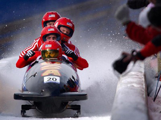 Bobsled team competing in Winter Olympics.