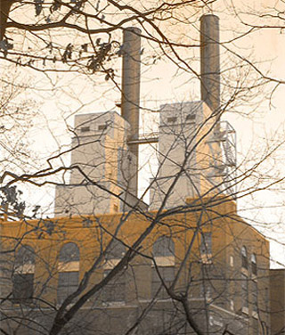 Outside of a factory building with smokestacks.