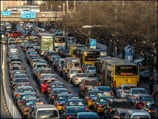 Cars lined bumper-to-bumper on highway.