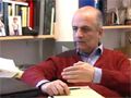 Professor Rabbat sits in an office in front of bookshelves and photos as he discusses the course.